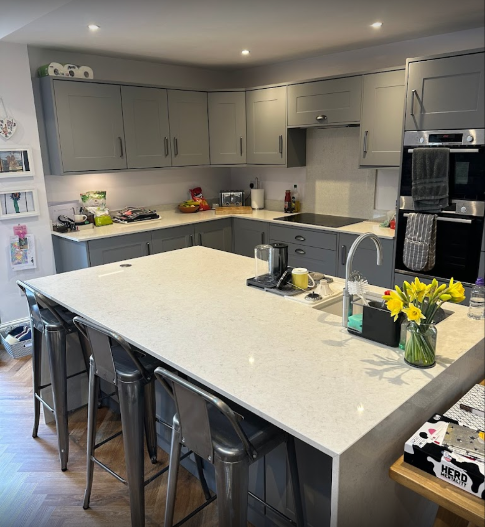 A kitchen with a large island and stools