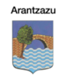 Escudo de Arantzazu: árbol, puente sobre el agua, fondo de cielo azul.