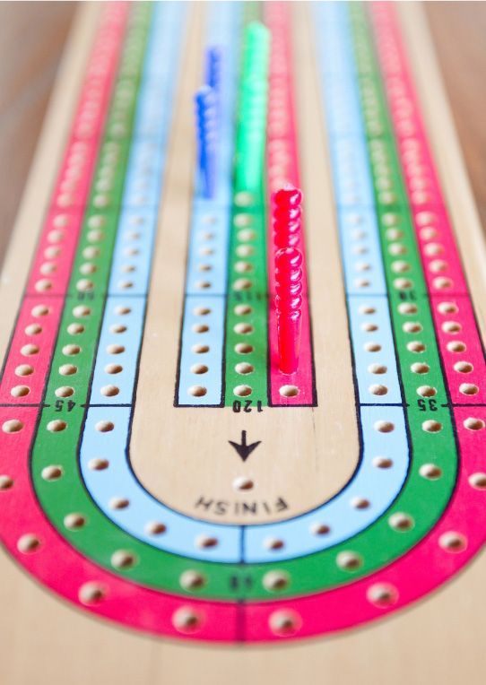 Colorful marble-run toy with pink, green, and blue tracks on a wooden surface