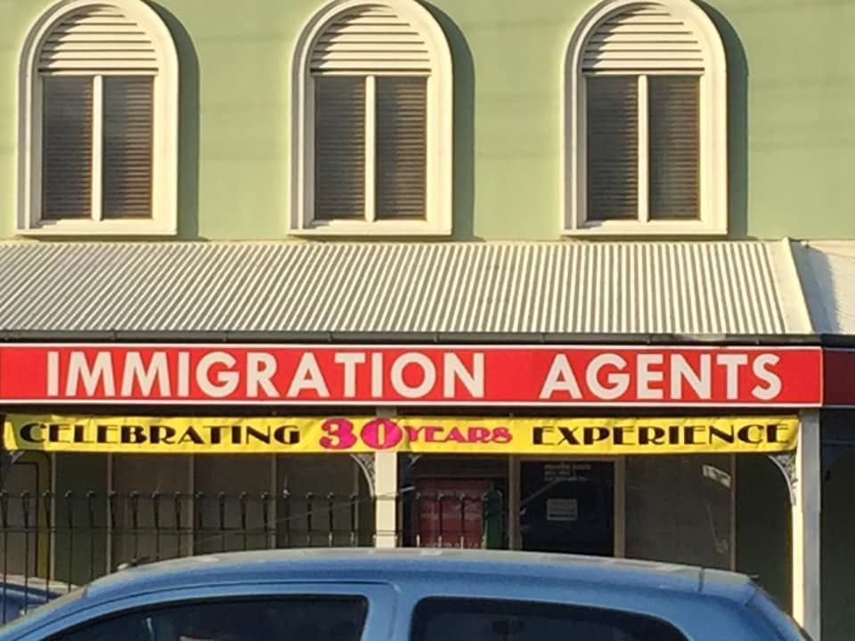 Sign for Immigration Agents With a Red Background — Immigration Agents in Cairns North, QLD