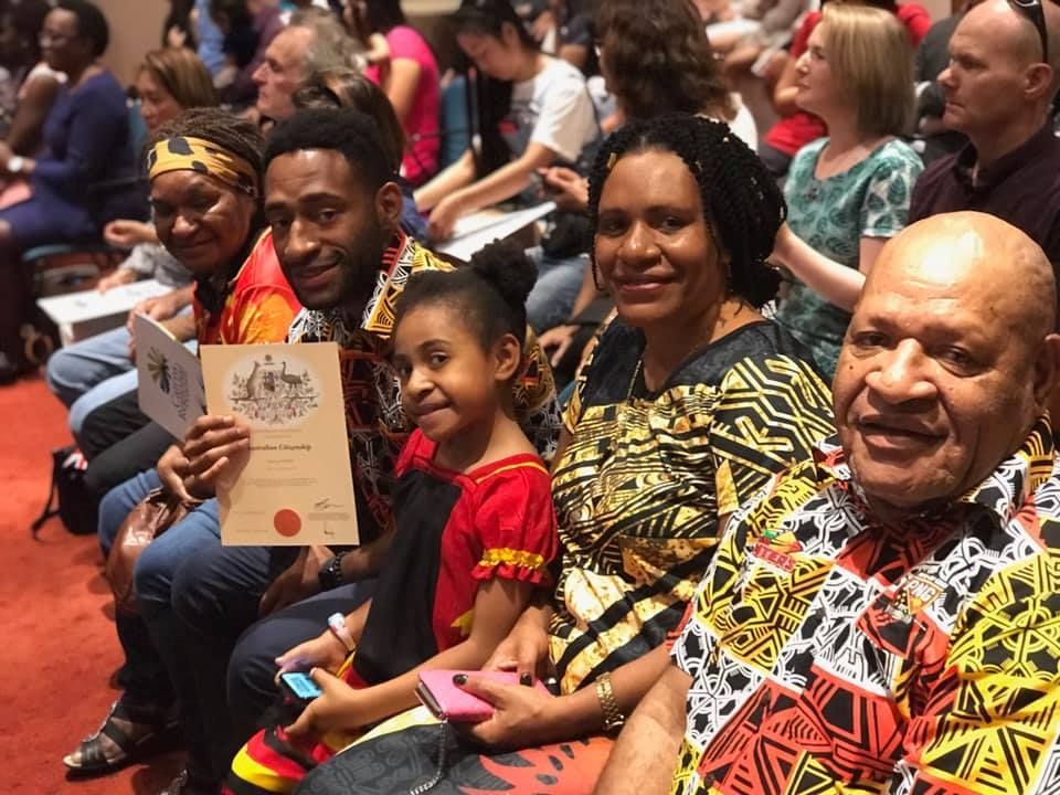 Family at a Naturalization Ceremony, Smiling — Immigration Agents in Cairns North, QLD