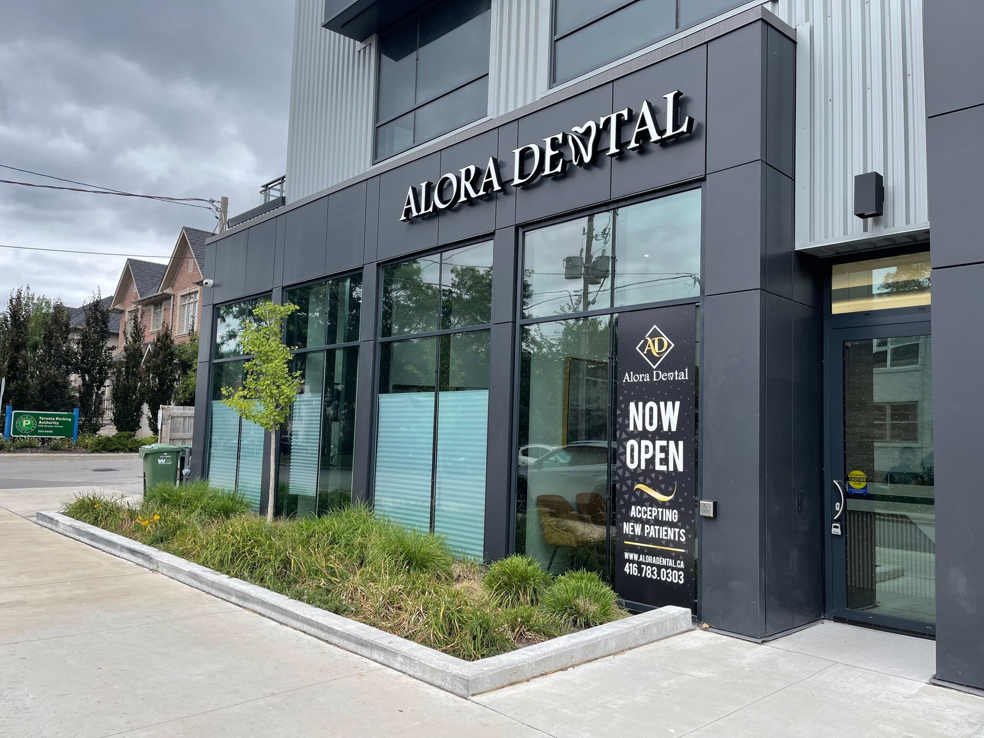 Exterior of Alora Dental office with sign, large windows, and a 