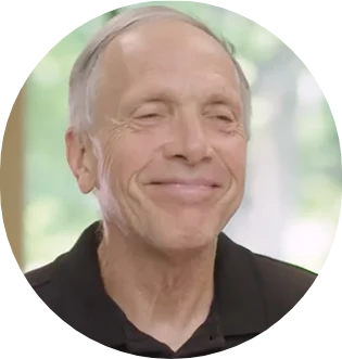 Smiling man in a black shirt against a blurred light background