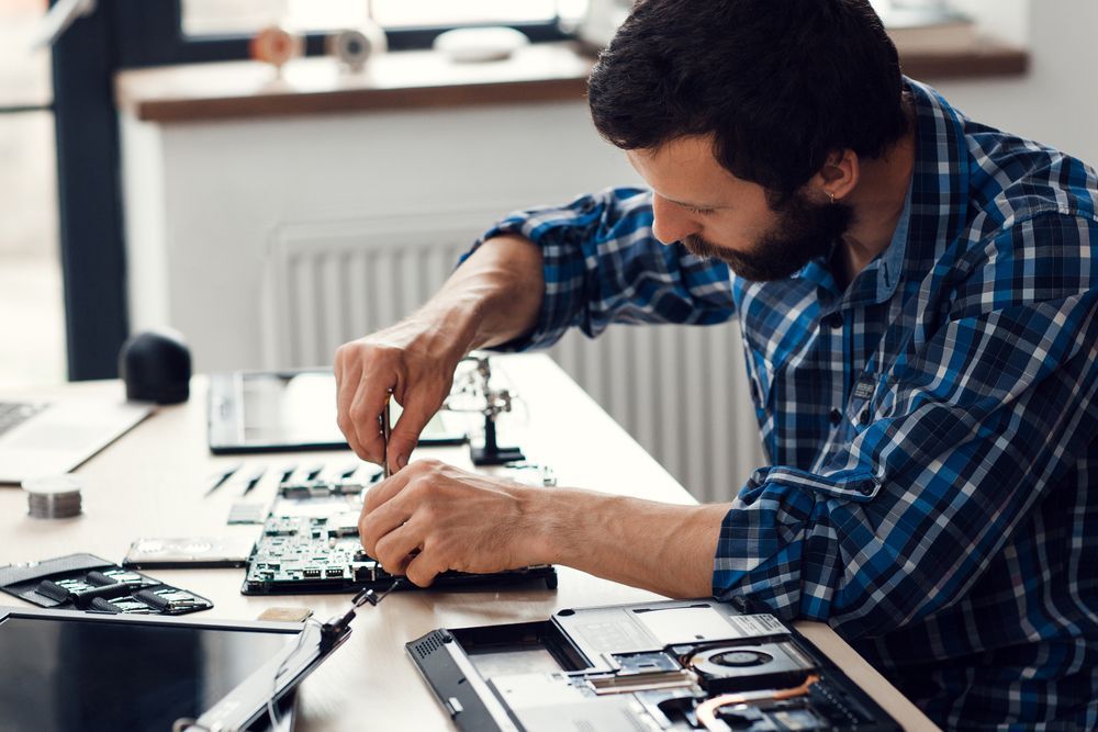 Person Using a Screwdriver to Assemble a Computer Inside Its Open Case — Micromac Computers in Central Coast, NSW