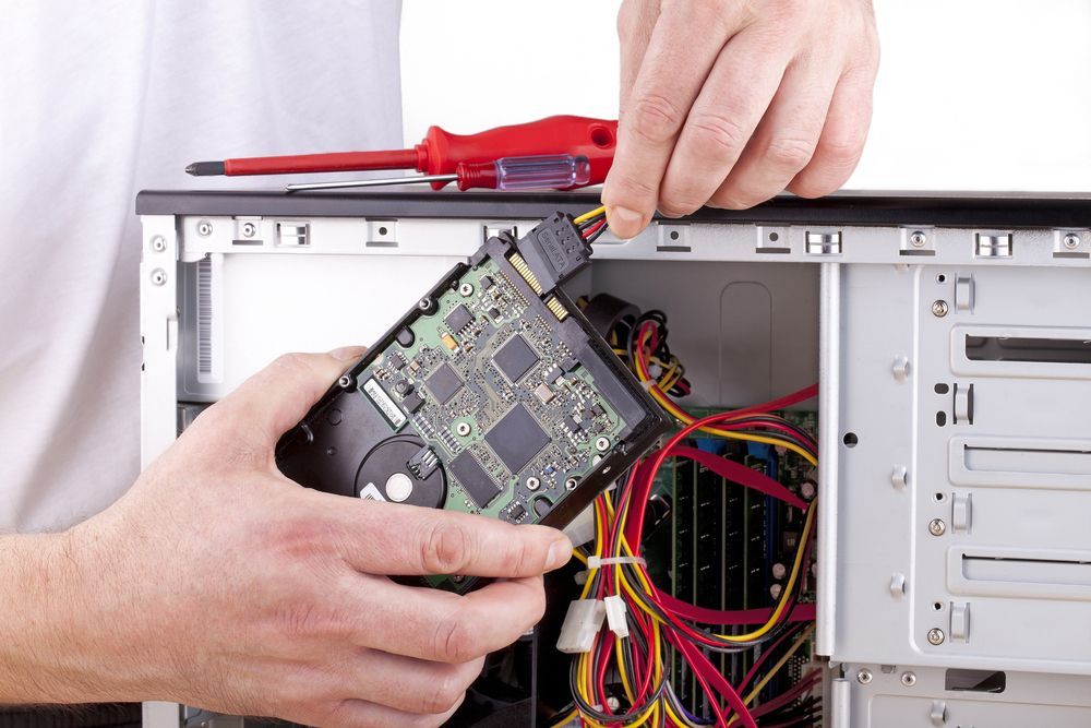 Person Connecting a Hard Drive to a Computer's Internal Components — Micromac Computers in Charmhaven, NSW
