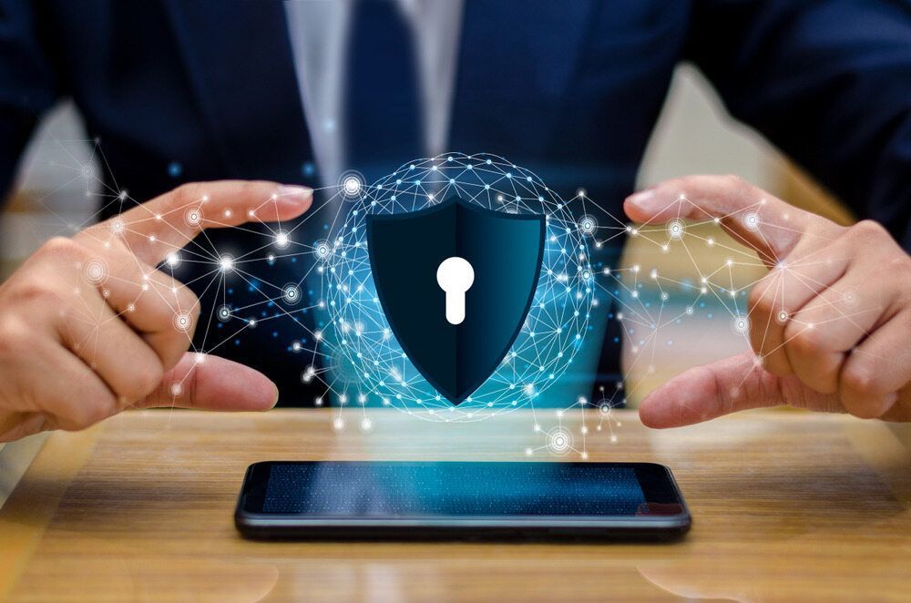 Hands Protecting a Digital Shield With a Keyhole, Symbolizing Data Security — Micromac Computers in Charmhaven, NSW
