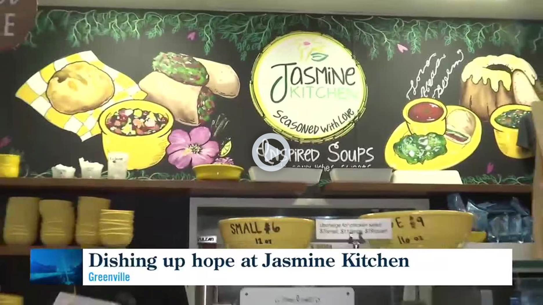 Jasmine Takeout counter with colorful fruit-and-soup menu board and “Dishing up hope” news caption