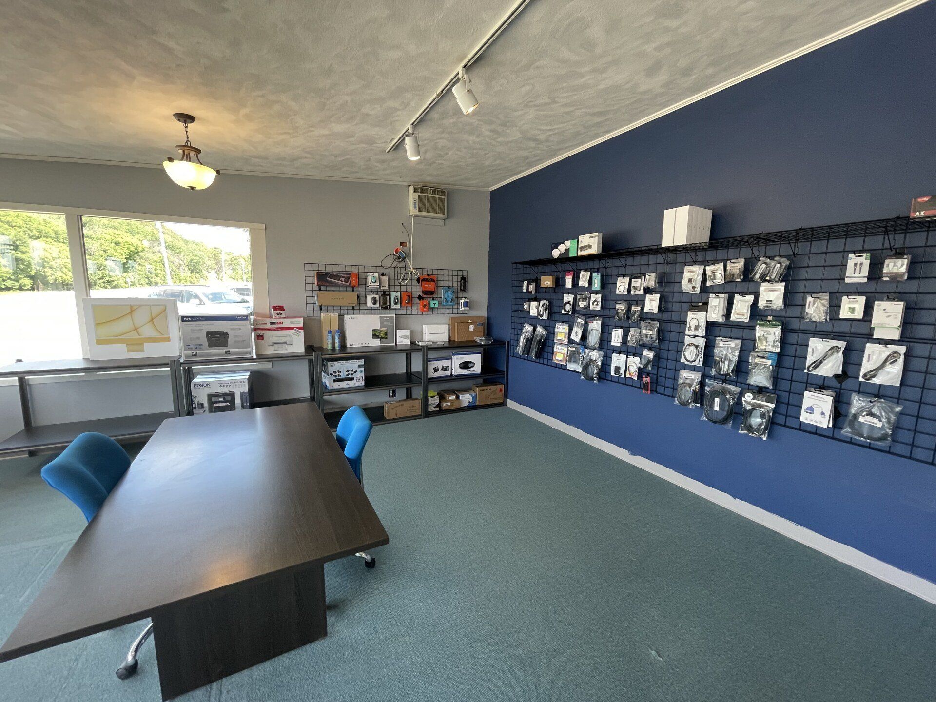 interior of stress less tech Decorah office front desk and conference table retail display back in the rear of the room