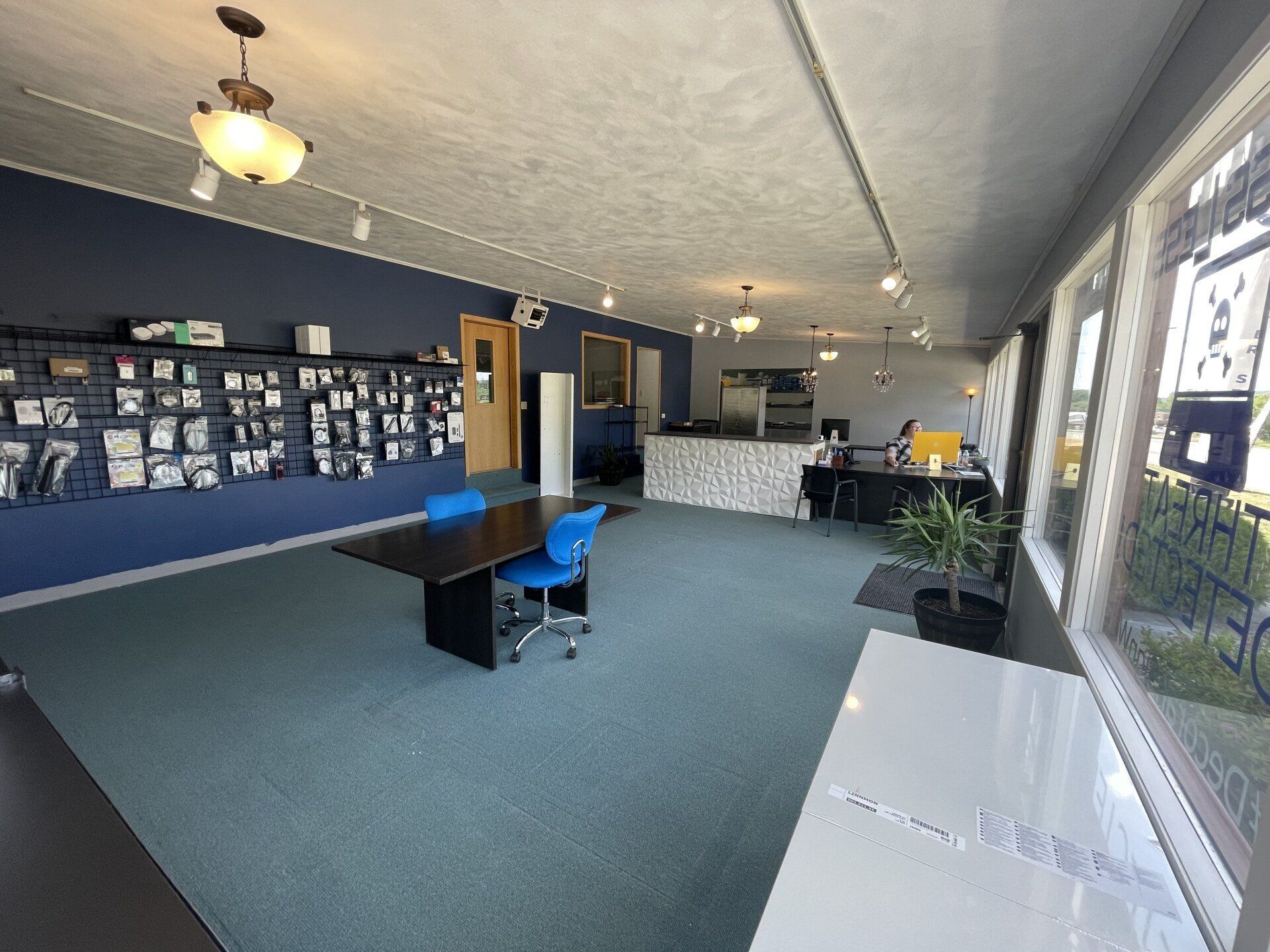 interior of stress less tech Decorah office front desk and conference table with blue chairs at the table