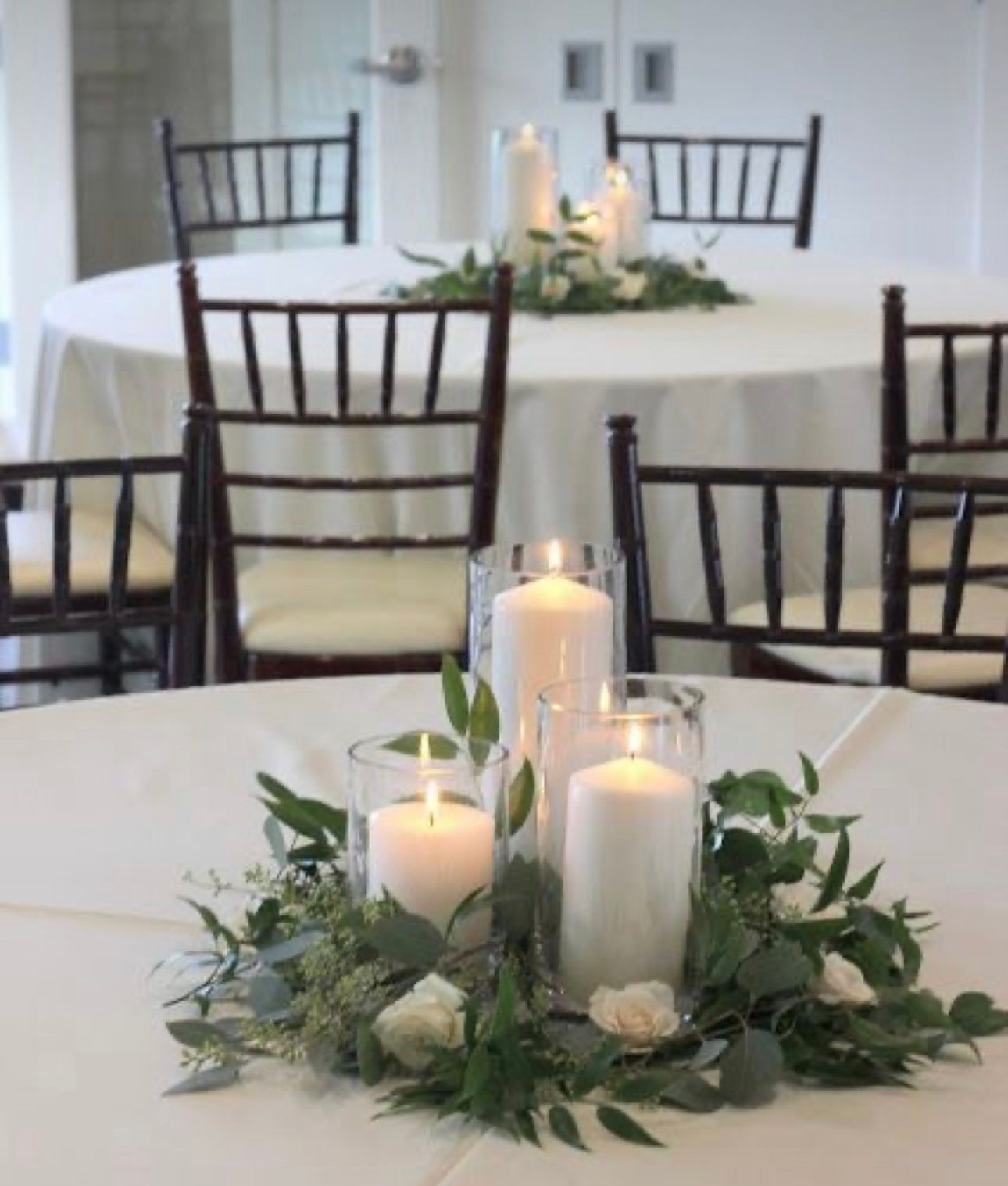 A table with candles and flowers on it