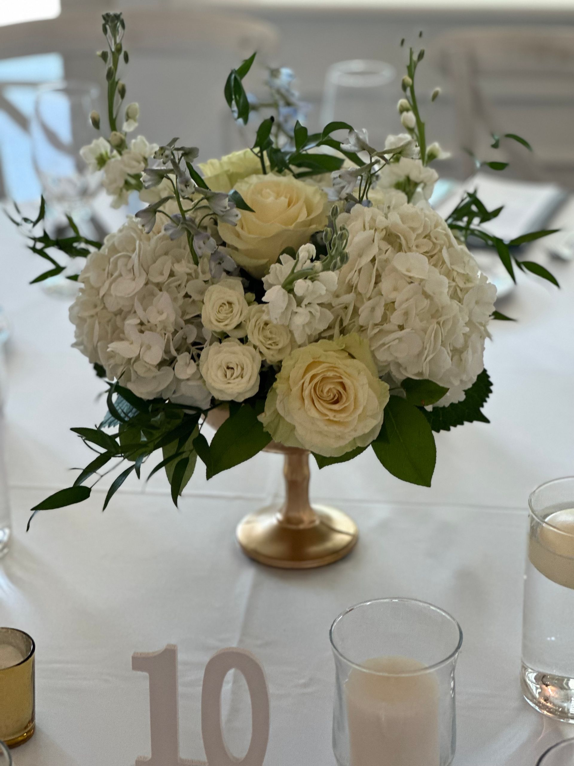 A table with a vase of flowers and a table number 10