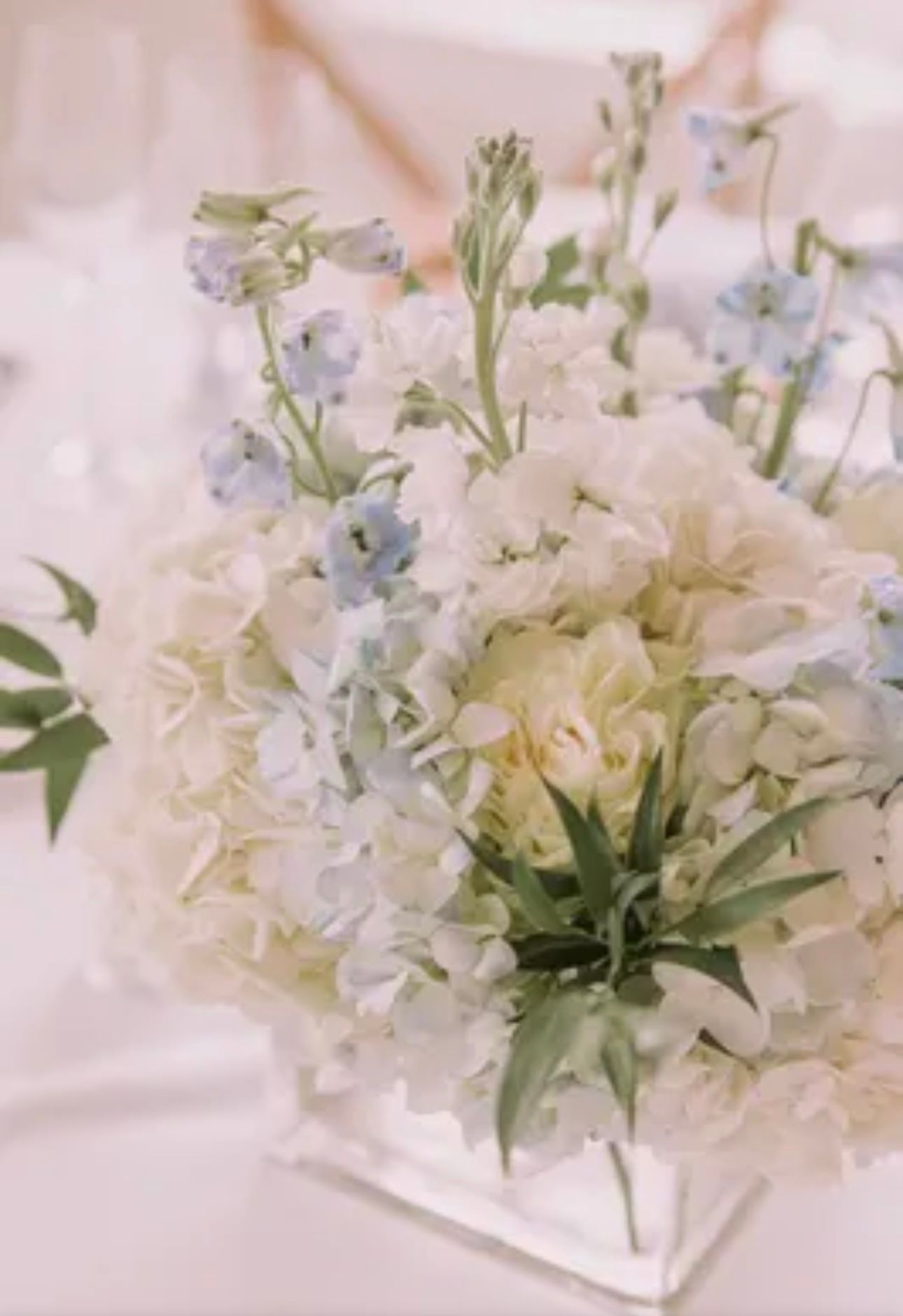 A large room with tables and chairs set up for a wedding reception.