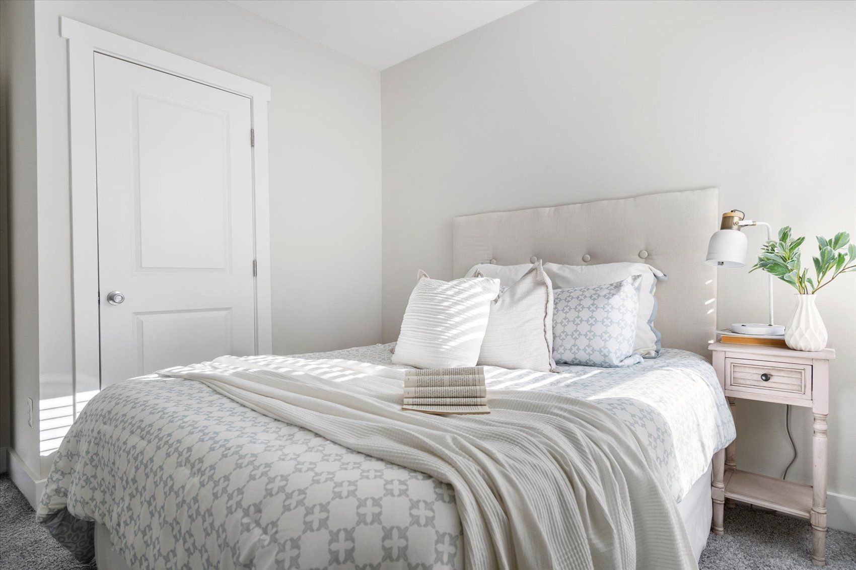 A bedroom with a bed , nightstand , and closet.