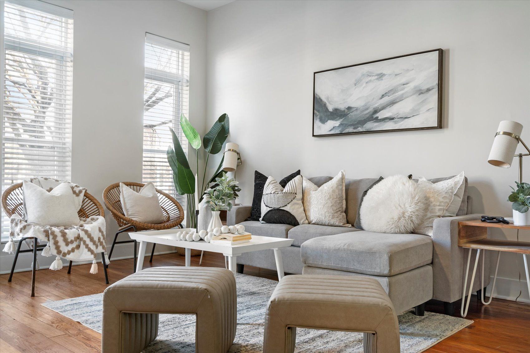 A living room filled with furniture and a painting on the wall.