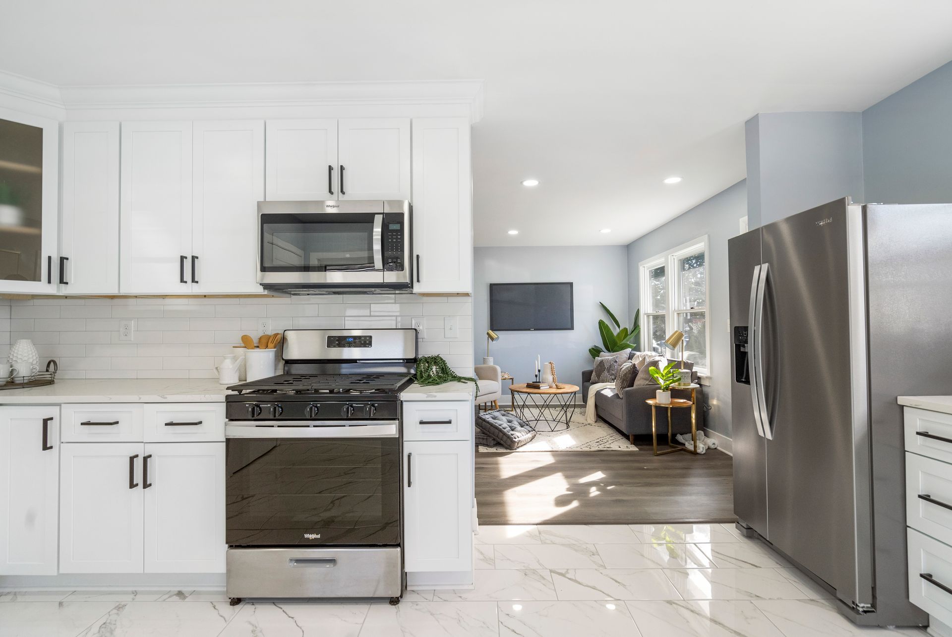 A kitchen with stainless steel appliances and white cabinets