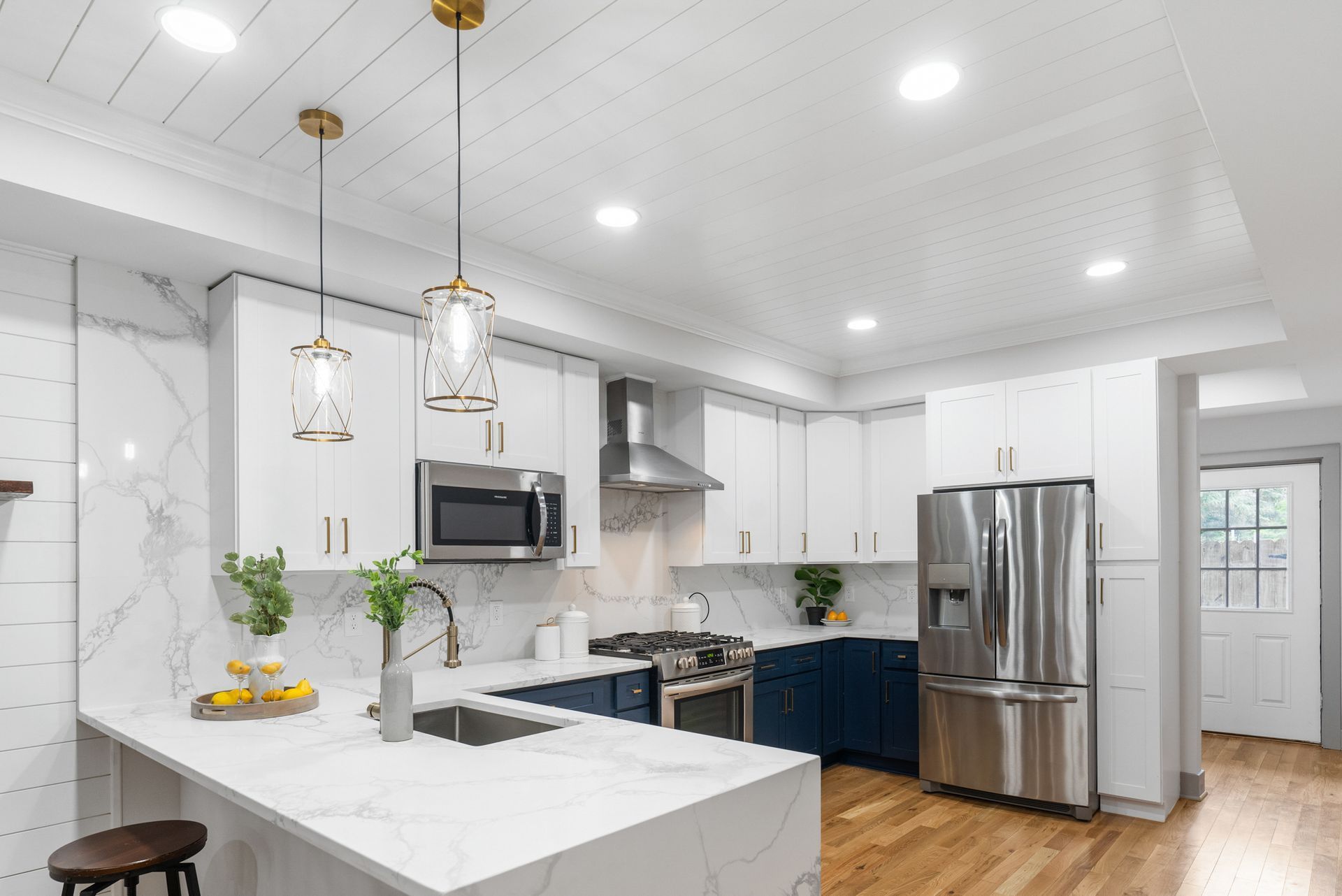 A kitchen with white cabinets and stainless steel appliances.
