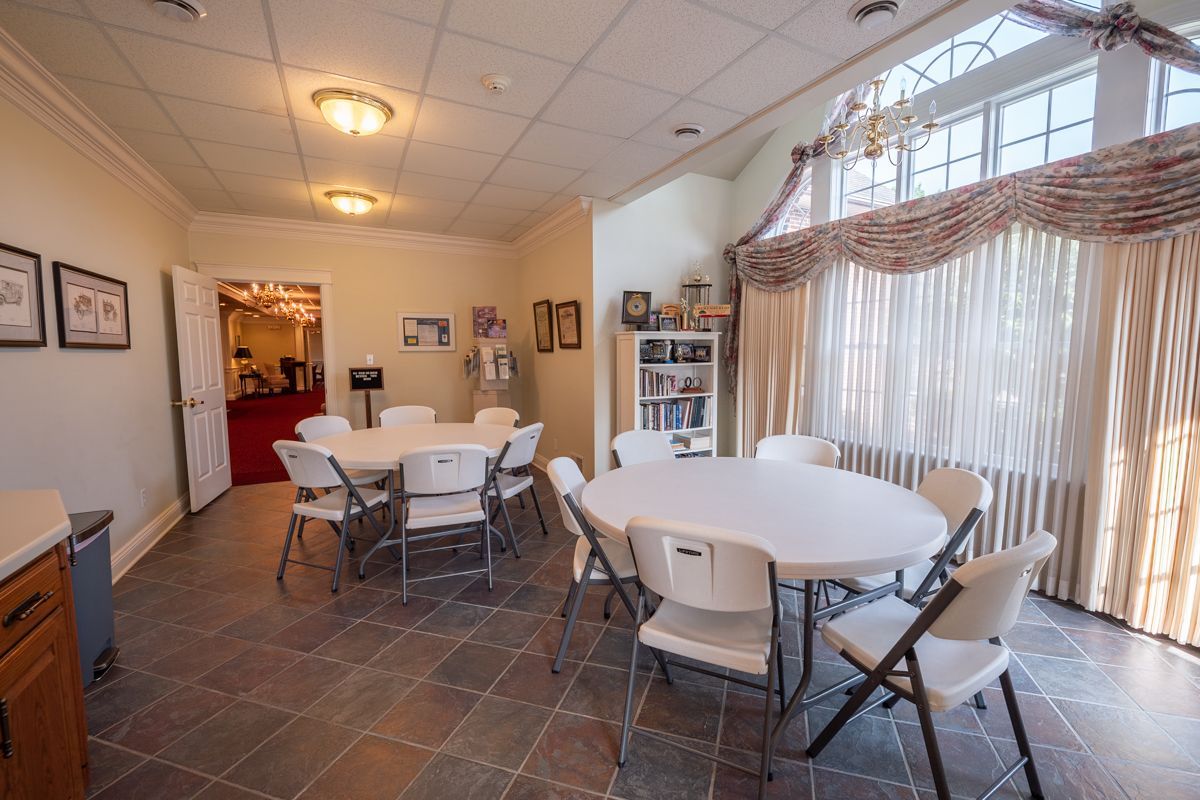 A room with a table and chairs in it