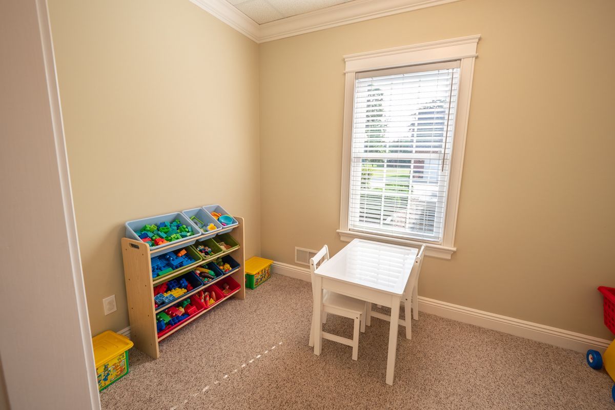 A child 's room with toys and a flat screen tv