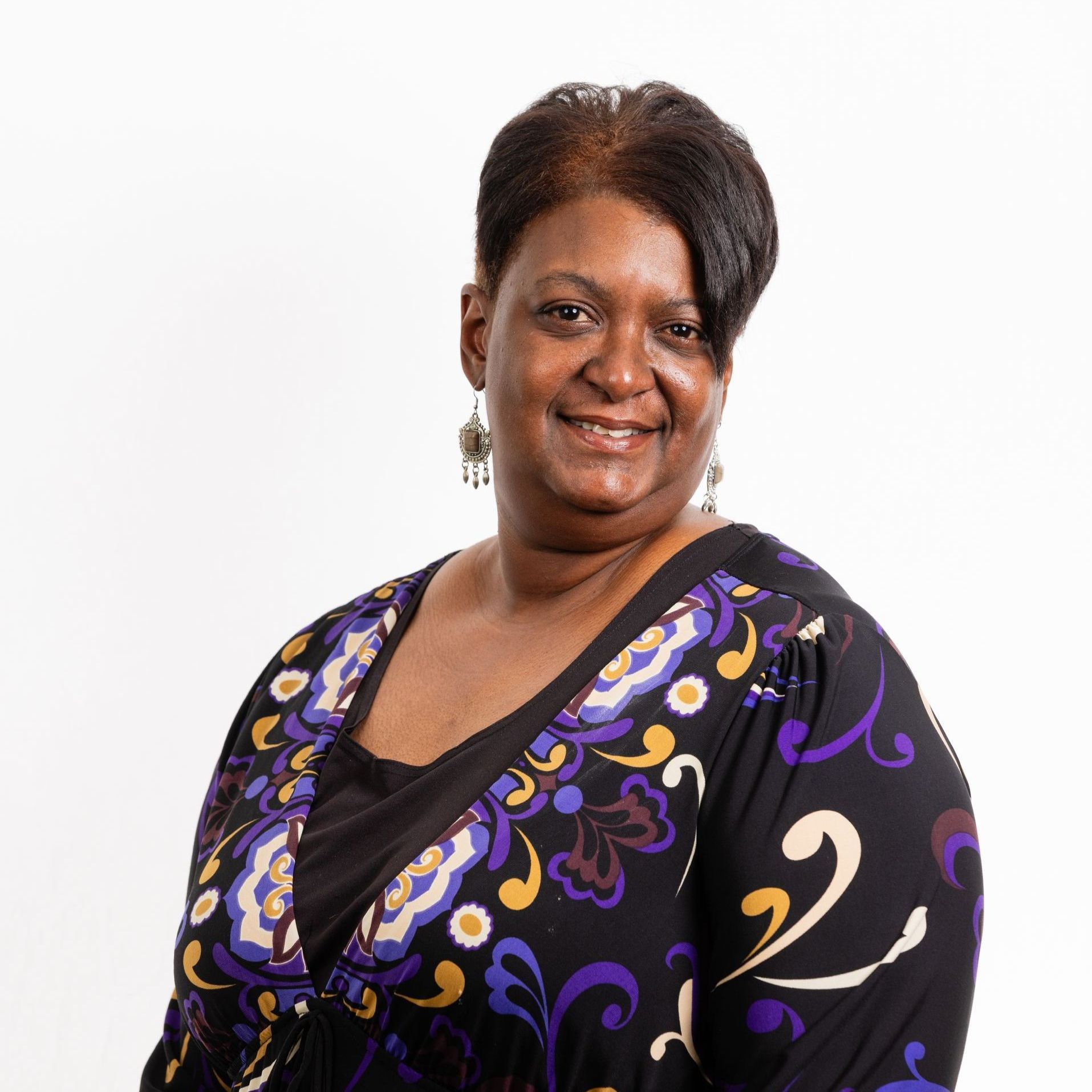 A woman wearing a purple and black shirt with the number 2 on it