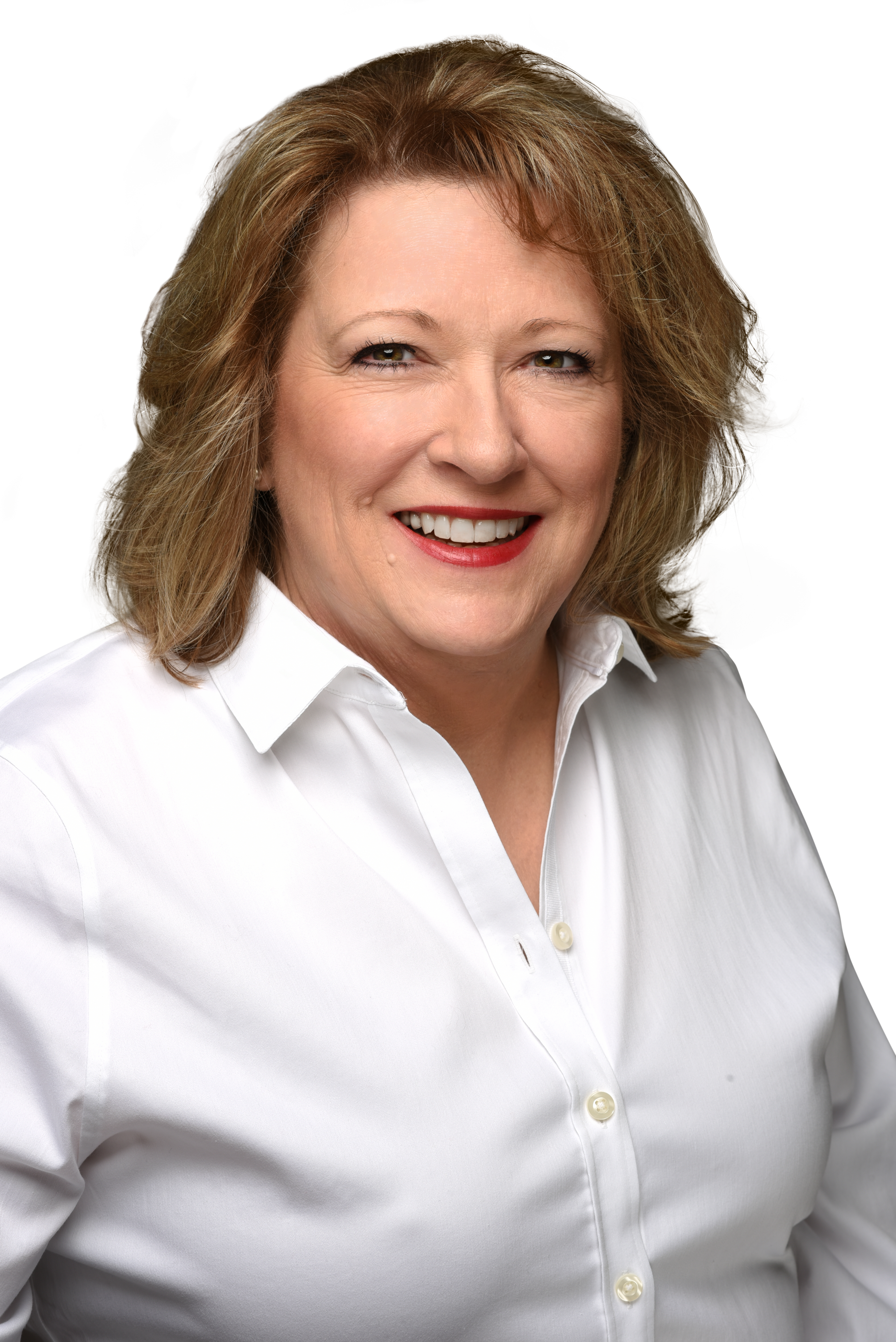 A woman in a white shirt is smiling for the camera.