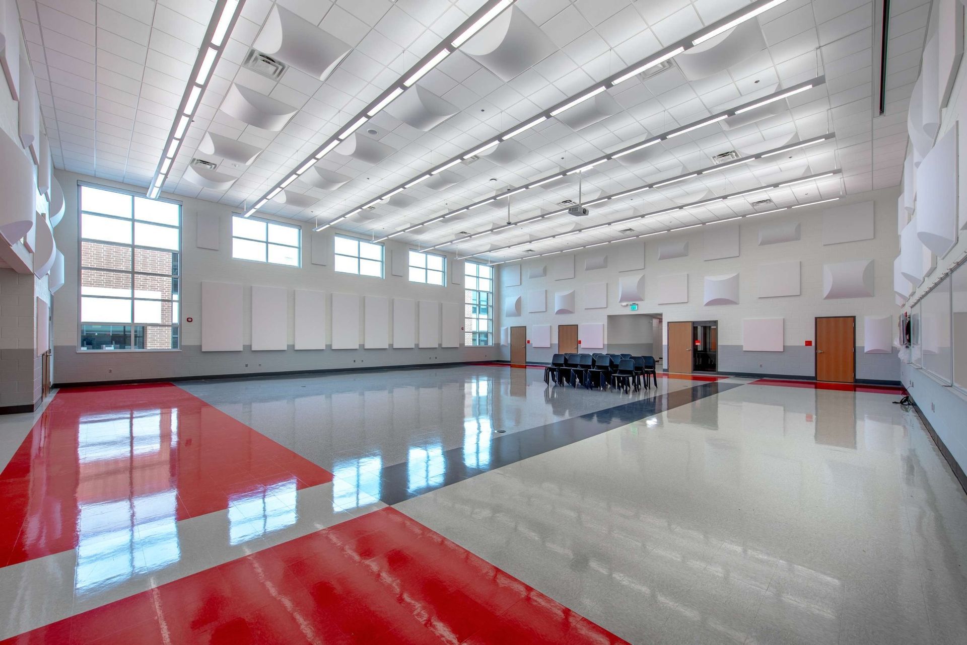 A large empty room with a red and white floor