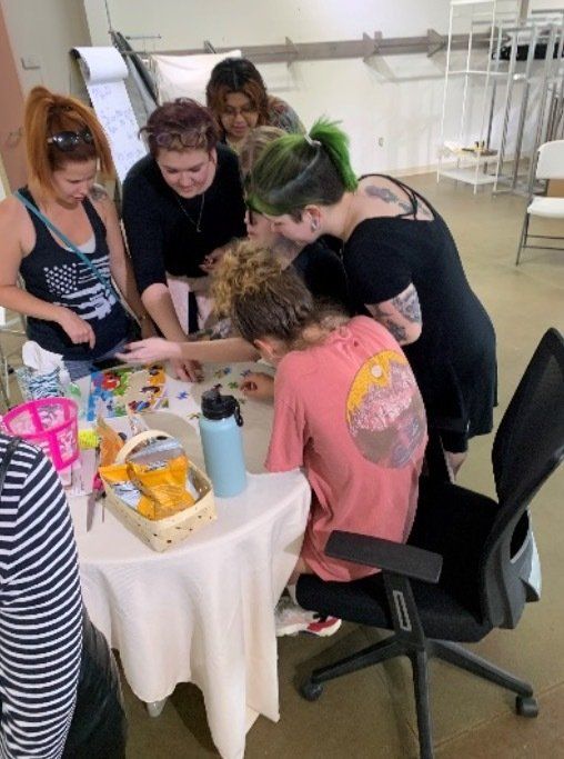 A group of people are gathered around a table