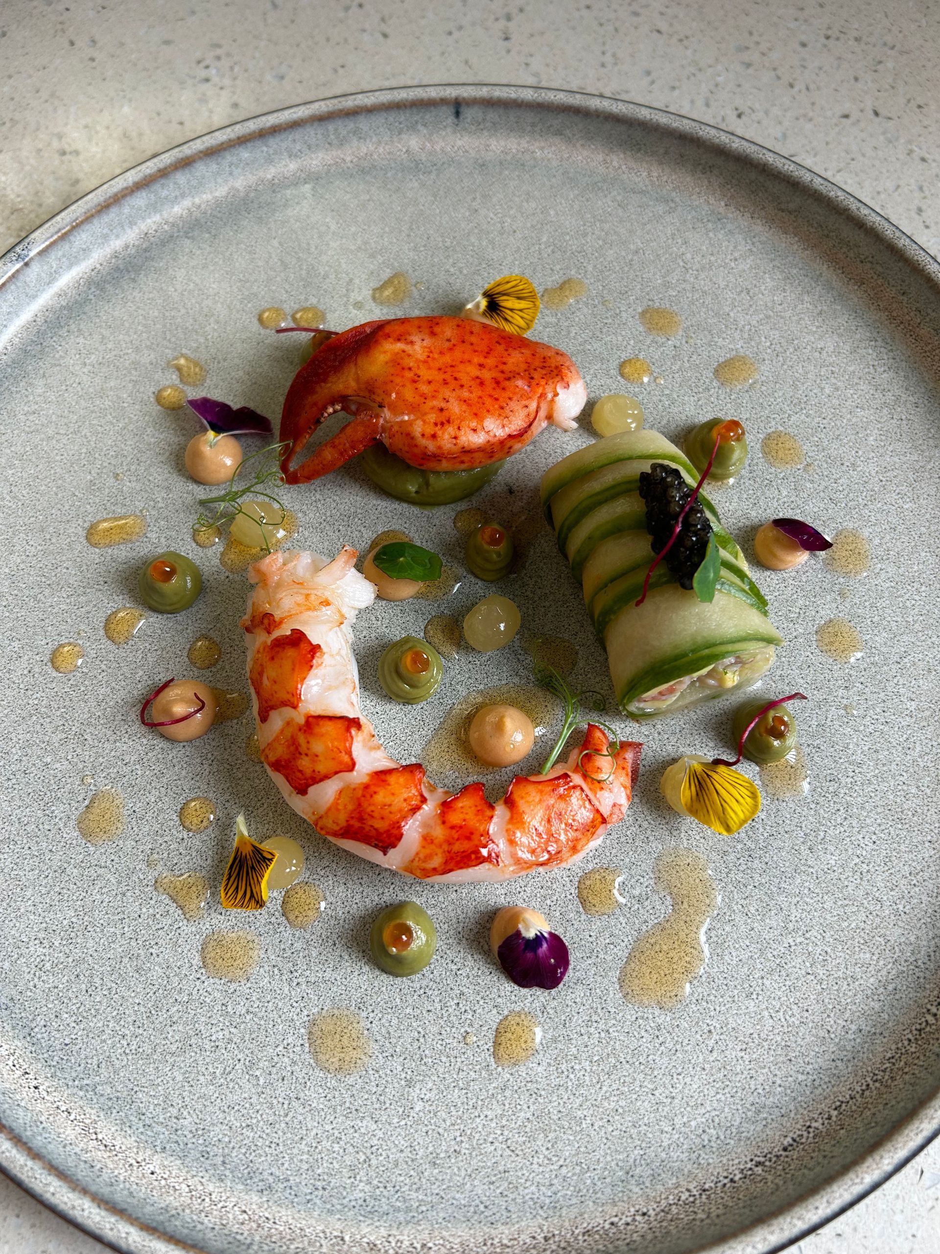 A plate of food with meat and vegetables on a table.