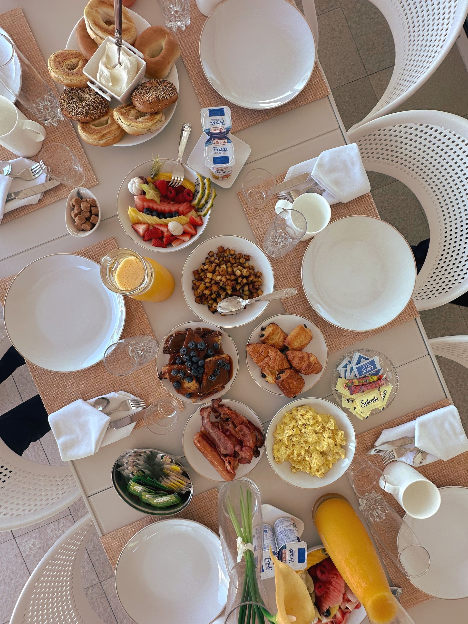 A table topped with plates and bowls of food.