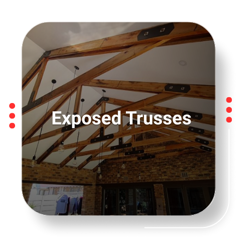 Exposed wooden roof trusses, interior view with brick and white ceiling, modern architecture.