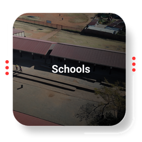 Aerial view of a school building with a red roof, labeled 