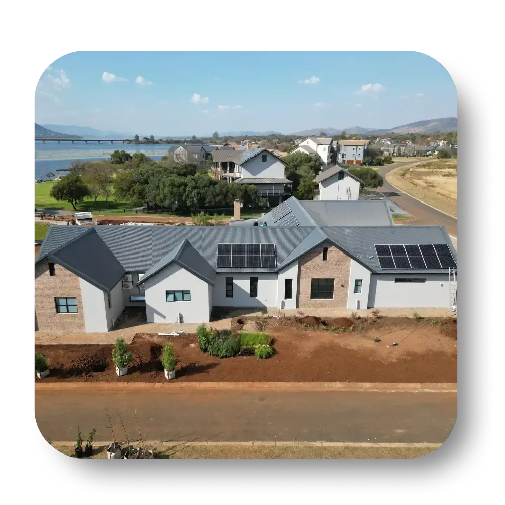 Modern brick houses in a new suburban neighborhood with solar panels and a coastal view