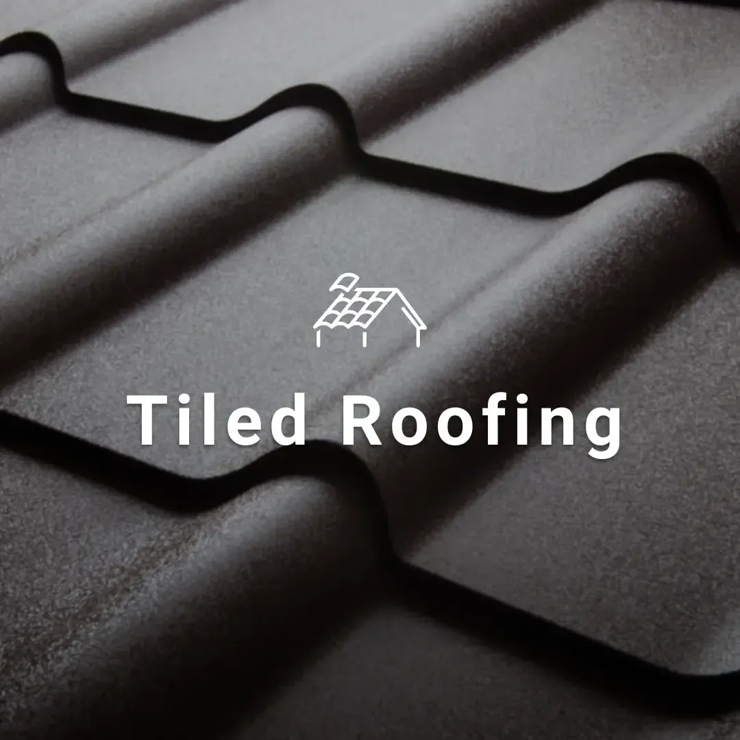 Dark gray tiled roof close-up with white “Tiled Roofing” text and roof icon