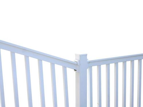 White wooden fence corner against a bright sky