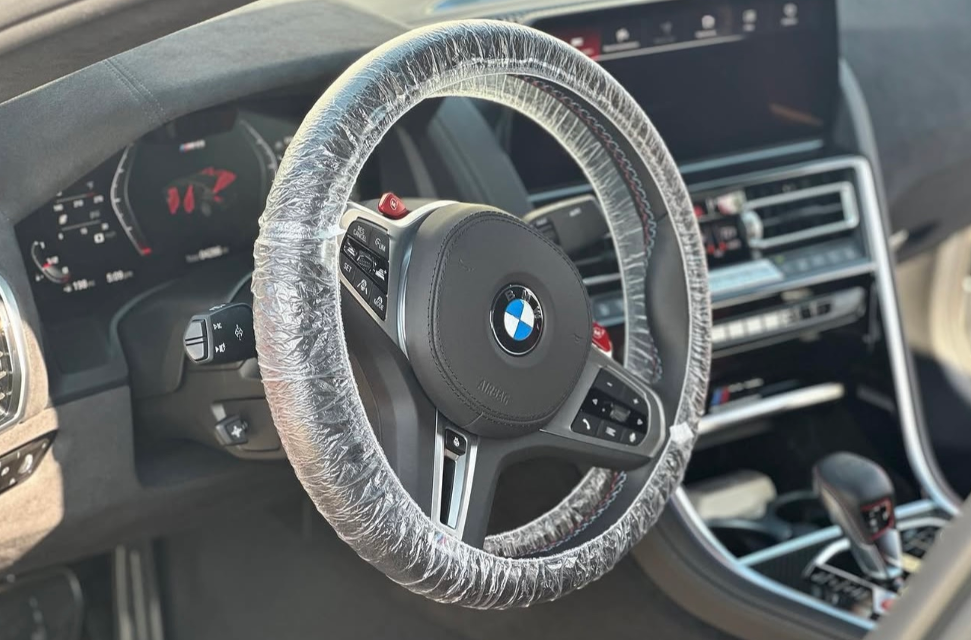 Gray car front seat and center console interior with cup holders and black trim