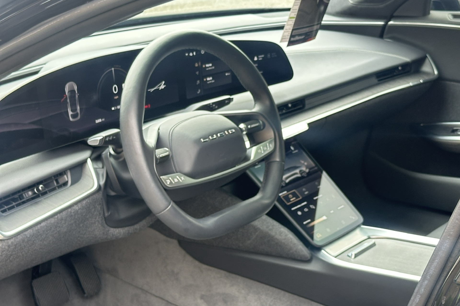 Open fuel door on a black car, showing the fuel filler cap and tank opening.