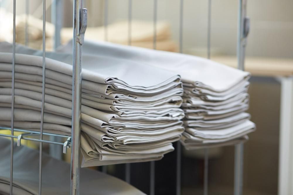 A Stack of Linen Sitting on Top of a Metal Rack — Tuncurry Washerteria In Tuncurry, NSW