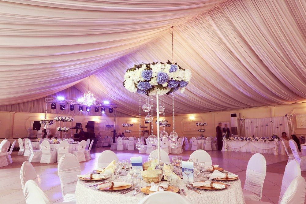 A Large Tent With Tables and Chairs Set Up for a Wedding Reception — Tuncurry Washerteria In Tuncurry, NSW
