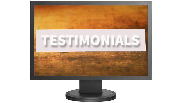 Computer monitor displaying the word “TESTIMONIALS” on an orange textured background