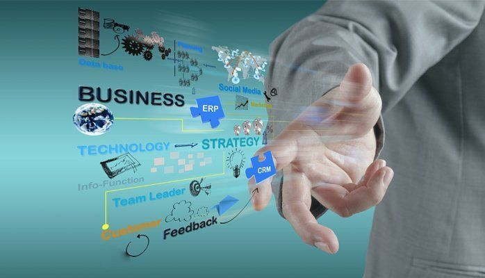 Business strategy concept with a pointing hand over blue digital interface labels and icons