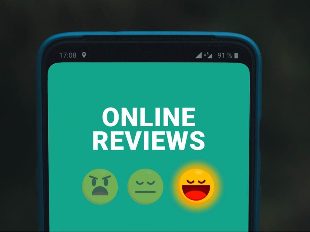 Phone screen showing “ONLINE REVIEWS” with three emoji faces from angry to happy on a teal background