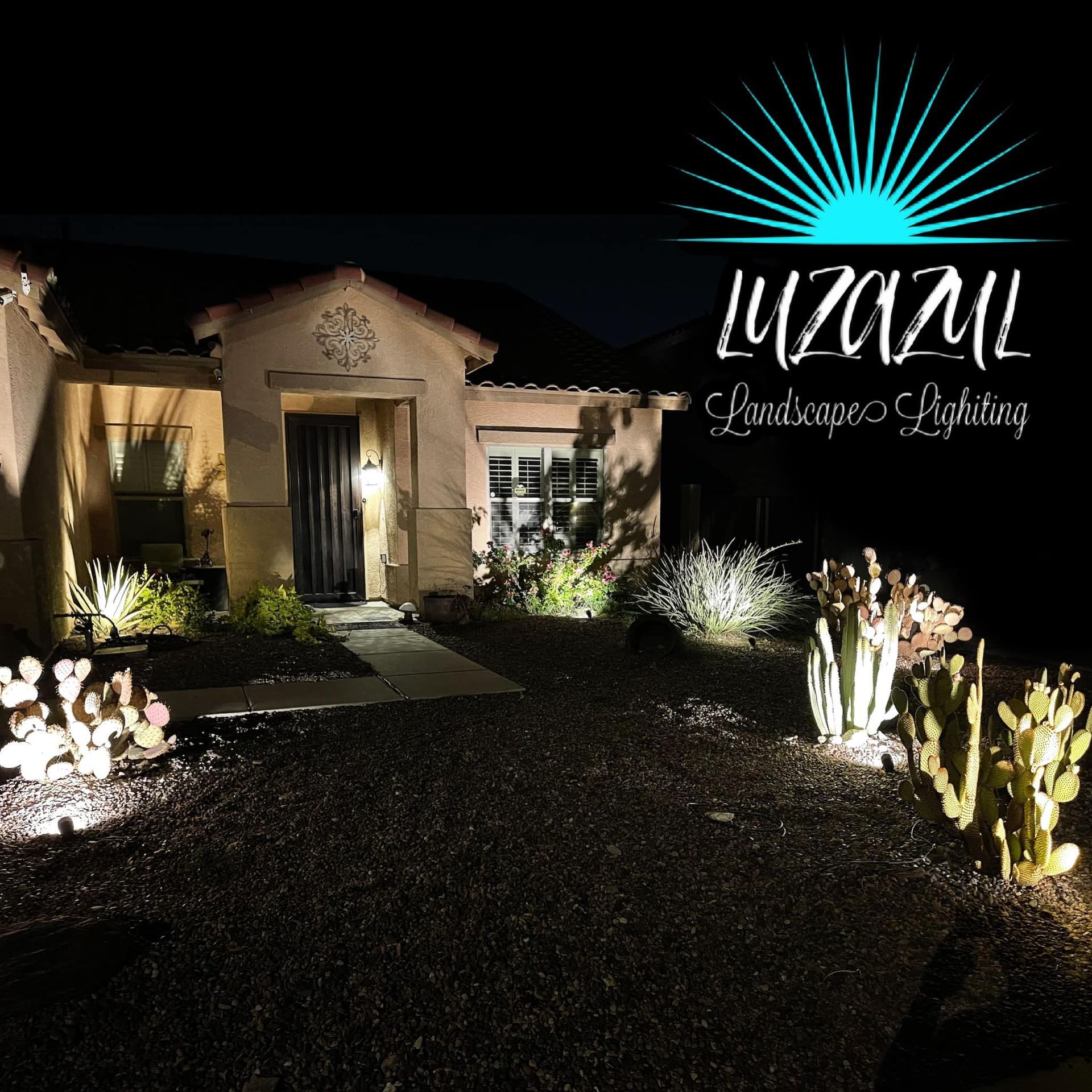 Night-lit house with illuminated landscaping and a glowing 