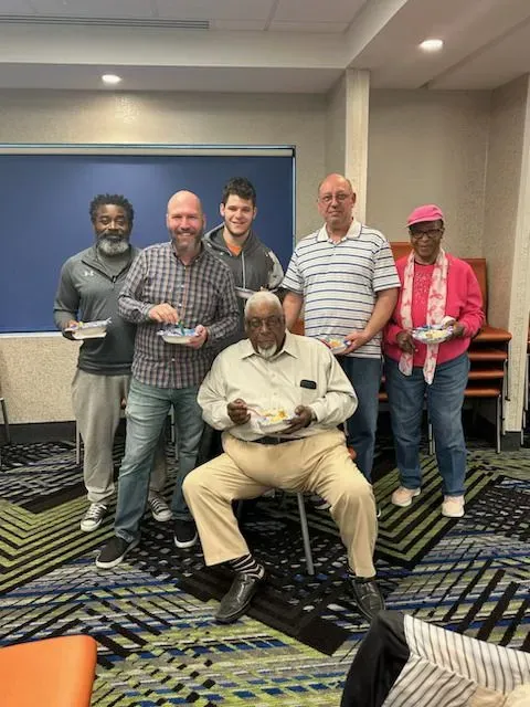 A group of people are posing for a picture in a room.