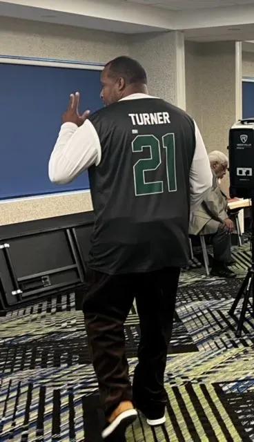 A man wearing a jersey with the number 21 on it