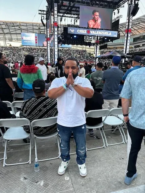 A man is standing in front of a crowd at a concert.