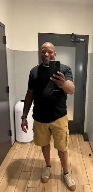 A man is taking a selfie in a bathroom.