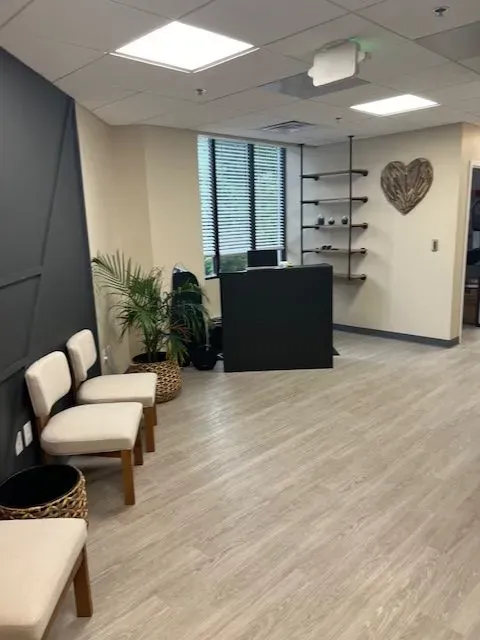 A waiting room with chairs and a heart on the wall
