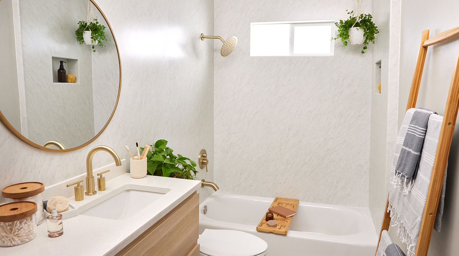 A bathroom with a sink , toilet , tub and mirror.