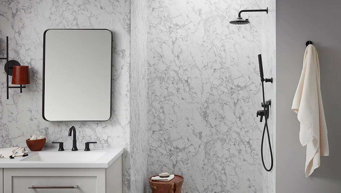 A bathroom with a sink , mirror , and shower.