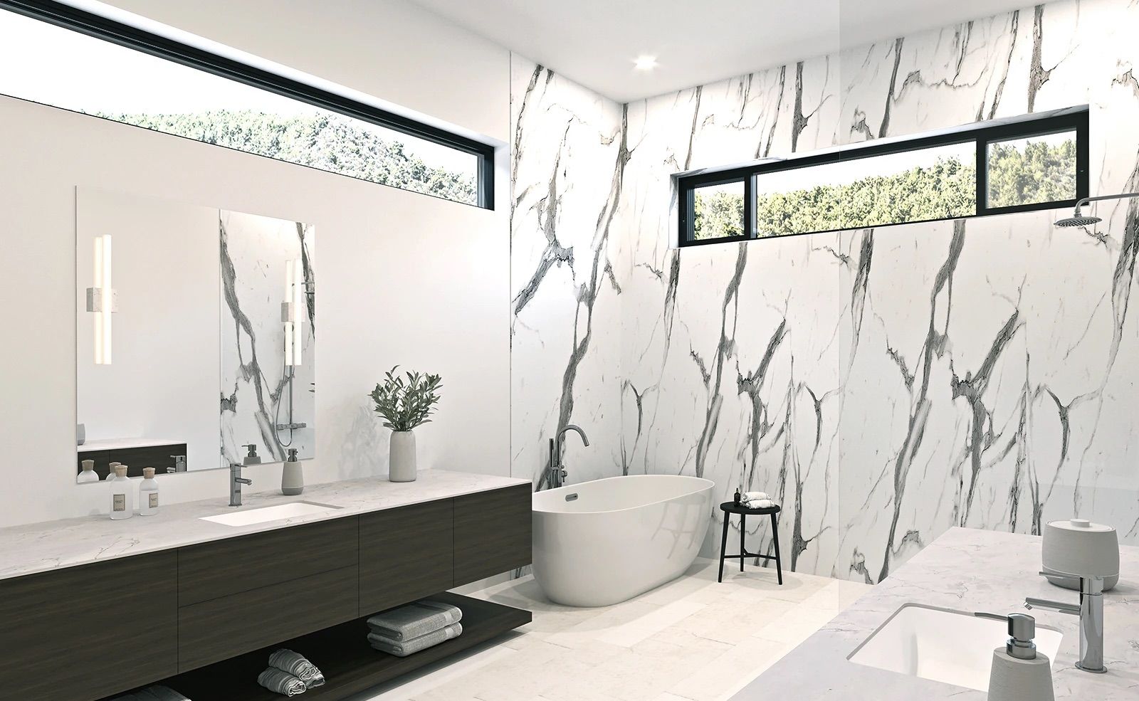 A bathroom with a bathtub , sink , mirror and marble walls.