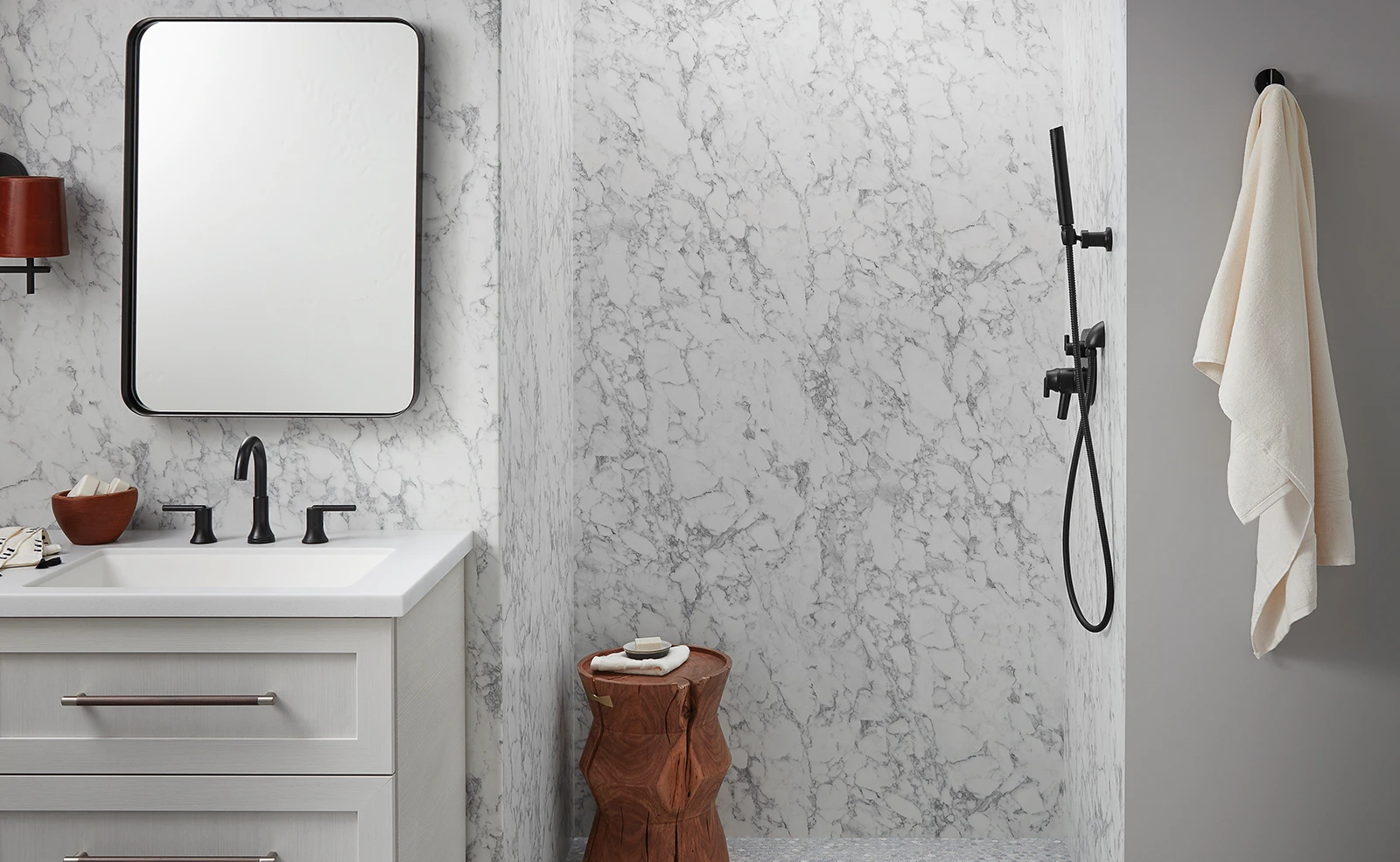 A bathroom with a sink , mirror , and shower.